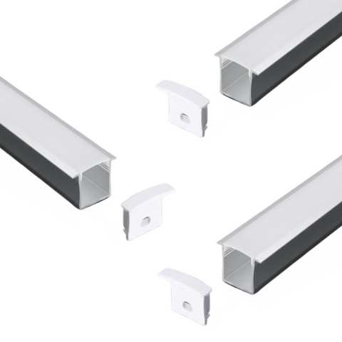 A set of three recessed LED profiles with milky white diffusers on a white background with their end caps.