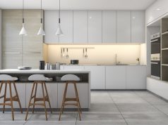 modern kitchen with three pendant lights and white cabinets