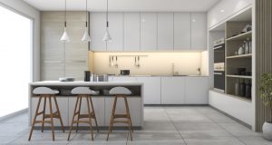 modern kitchen with three pendant lights and white cabinets