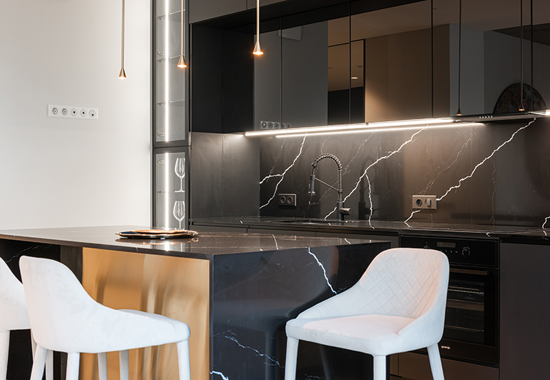 kitchen with black marble backsplash and black cabinets