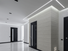 white hallway with cool white LED strips on the ceiling