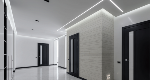 white hallway with cool white LED strips on the ceiling