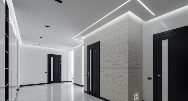 white hallway with cool white LED strips on the ceiling