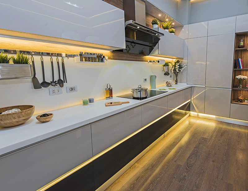 kitchen with warm white under cabinet lights and kickboard lights