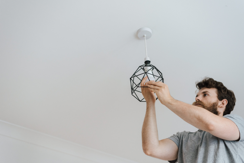 bearded man replacing bulbs with LED