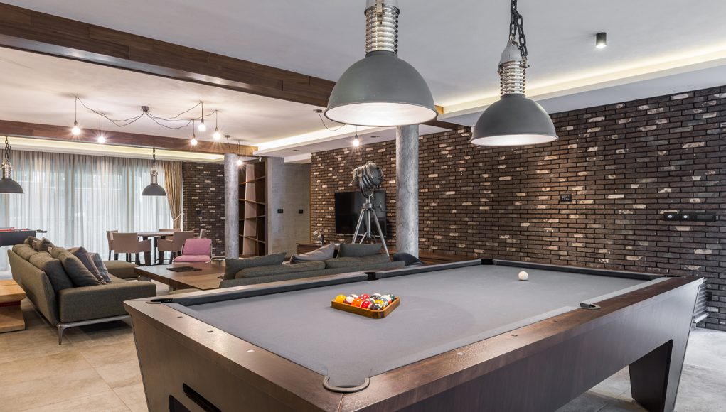 Man Cave with a pool table, and led lighting with TV on the wall