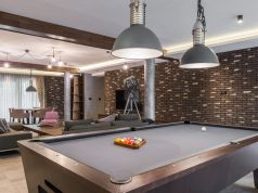 Man Cave with a pool table, and led lighting with TV on the wall