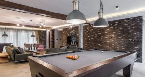 Man Cave with a pool table, and led lighting with TV on the wall