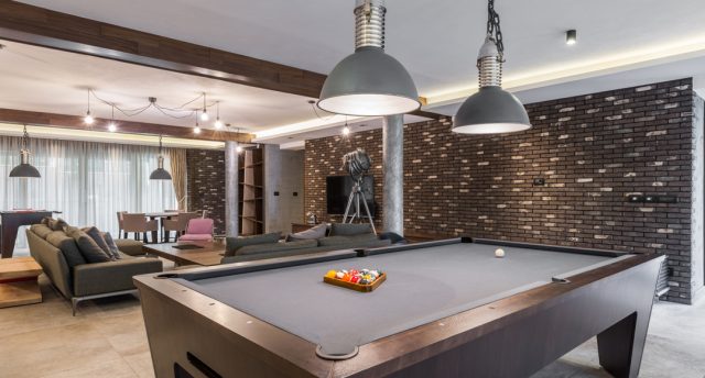 Man Cave with a pool table, and led lighting with TV on the wall