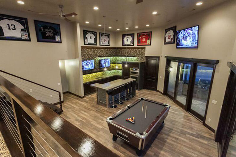 View of Man Cave from stairs, pool table and tv on wall