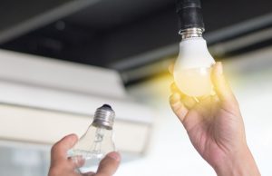 Hand with a lit light bulb