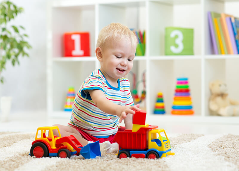 toddler playing with a truck