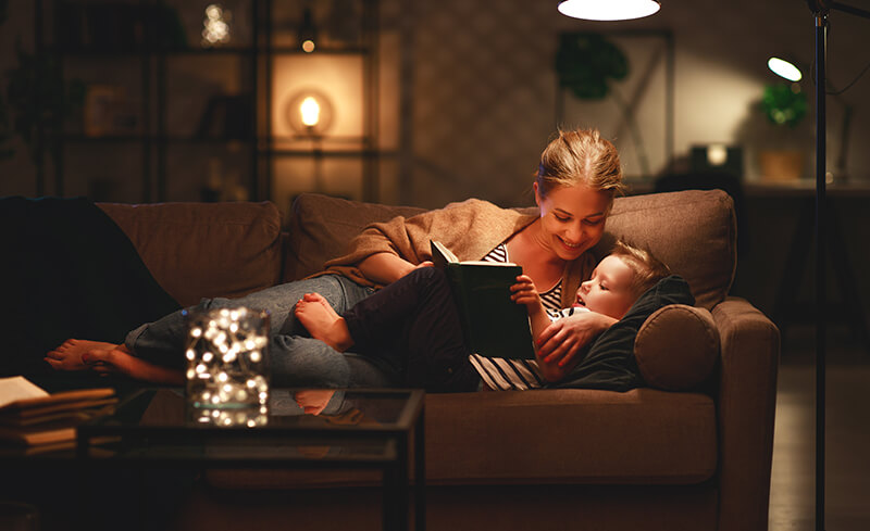 mother reading a book to a son