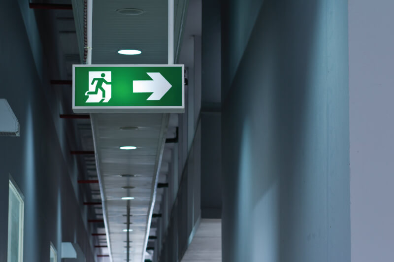 green exit sign with a man running