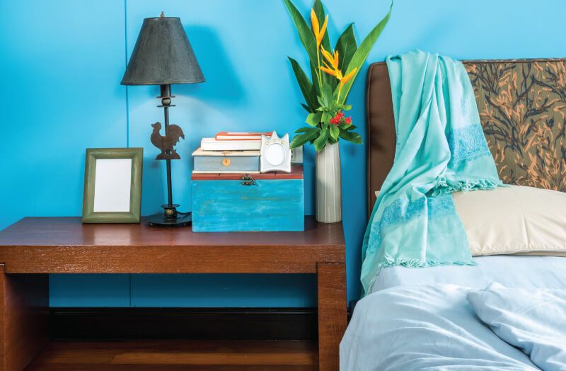 bedside table with lamps and blue box