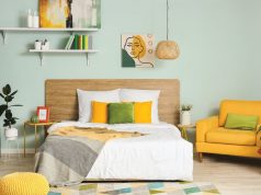 bedroom with yellow and green pillows and furniture