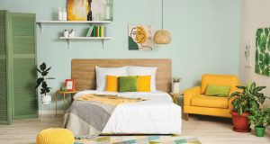 bedroom with yellow and green pillows and furniture