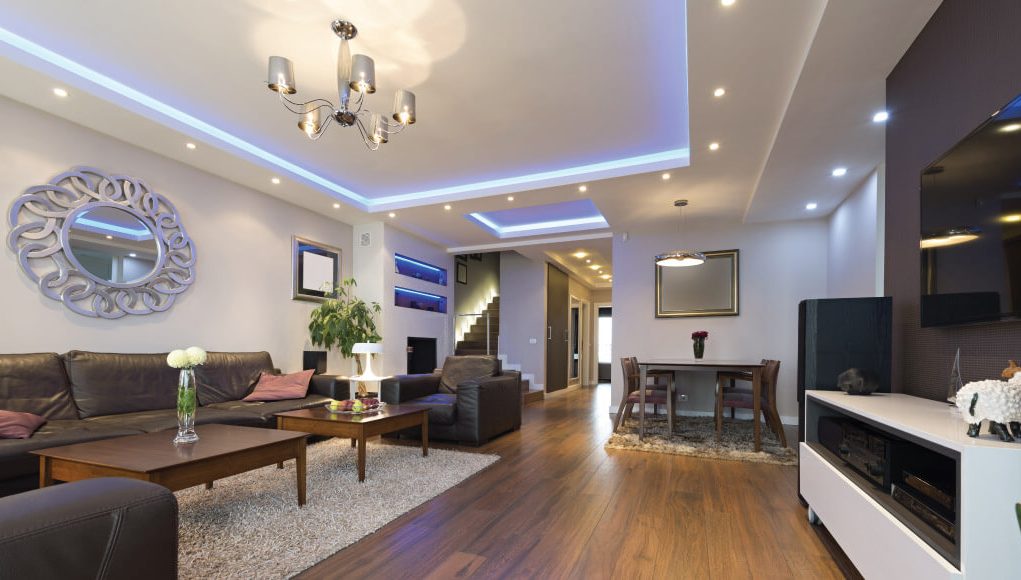 living room with wood floors and black sofa set