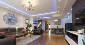 living room with wood floors and black sofa set