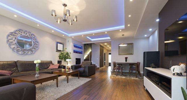 living room with wood floors and black sofa set