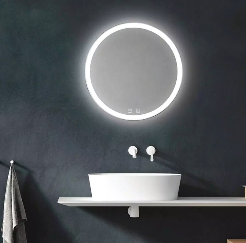 round LED mirror with a white sink below