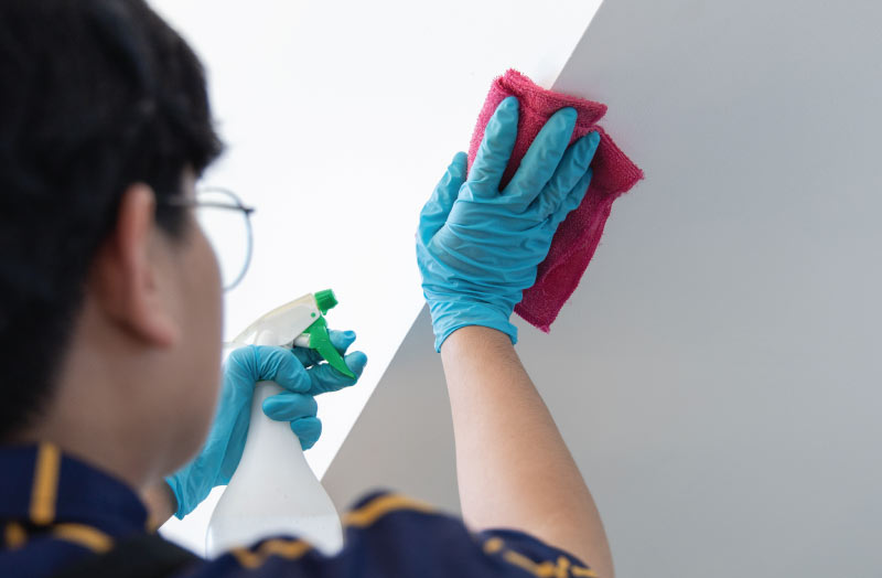 person cleaning a wall