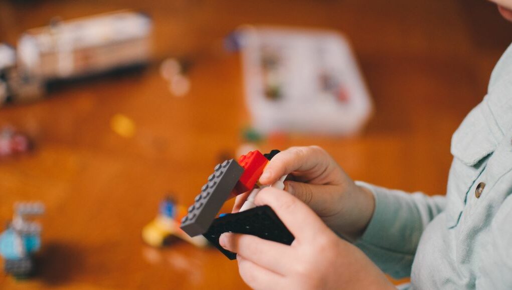 boy holding Legos