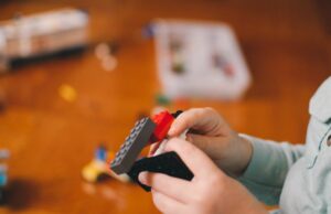 boy holding Legos