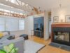 living room with light wood floors and beams