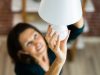 woman changing a light bulb