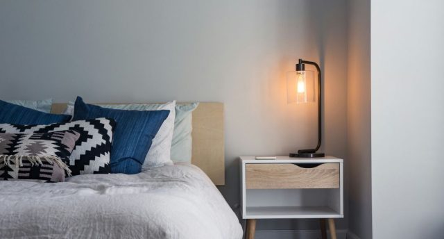 bedroom with warm white bedside table lamp
