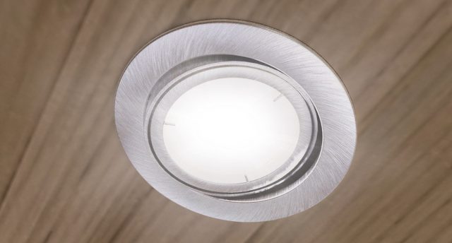 An LED downlight on a bedroom ceiling.
