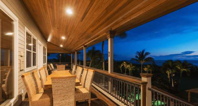 An elevated patio illuminated by LED downlights.