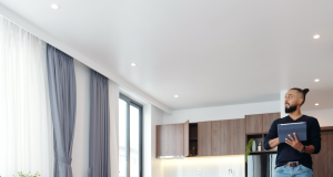 Man looking at the LED downlights on his ceiling.