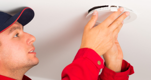 Man installing LED downlights on ceilings.