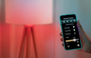 Homeowner holding their phone and adjusting their space's lighting.