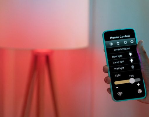 Homeowner holding their phone and adjusting their space's lighting.