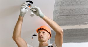 man changing lights