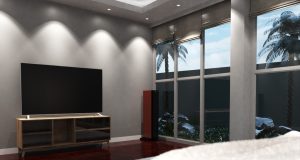 a bedroom illuminated by fire-rated downlights.