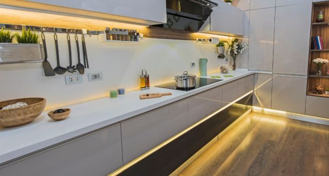 A complete kitchen with lighted LED strip lights