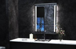 Lighted LED bathroom mirror over black tiles