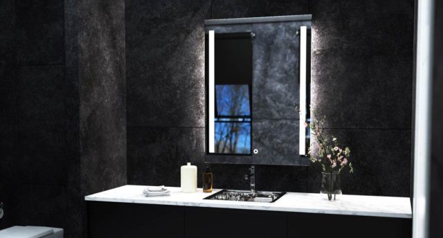 Lighted LED bathroom mirror over black tiles