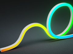 a lighted side-bending neon light in black background