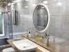 Bright bathroom with a lit round LED mirror