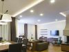 dining and living area with visible downlights and led strip lighting