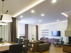 dining and living area with visible downlights and led strip lighting