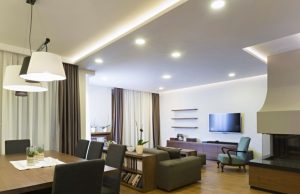 dining and living area with visible downlights and led strip lighting