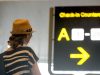 Woman looking at backlit airport sign