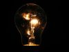 Lit incandescent light bulb with visible filaments