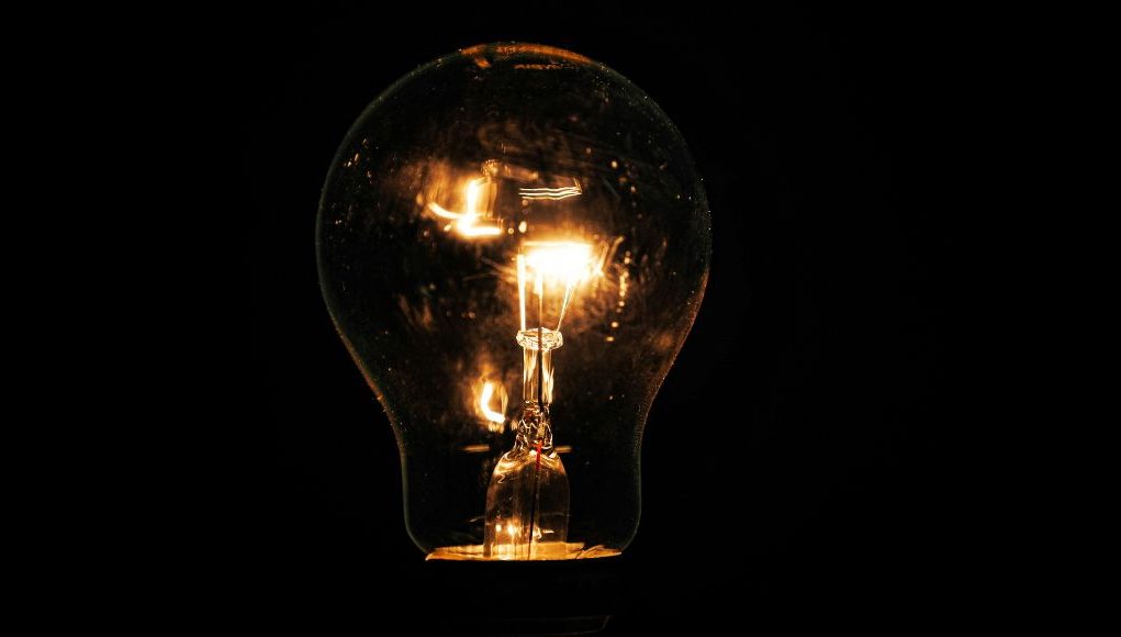Lit incandescent light bulb with visible filaments
